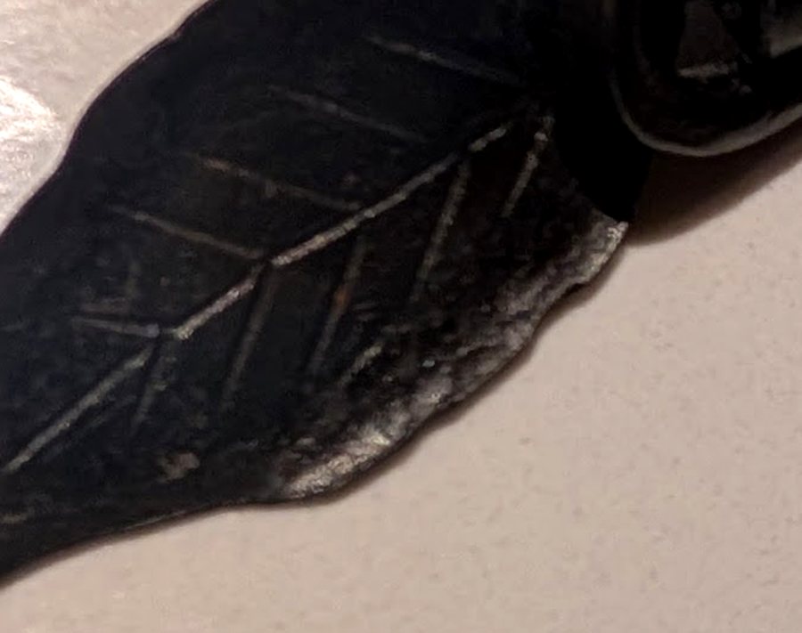 Close-up of the hand-chiselled veins on the steel leaf